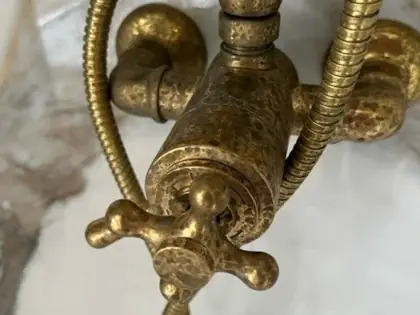 Brass shower mixer showing pitting due to limescale damage